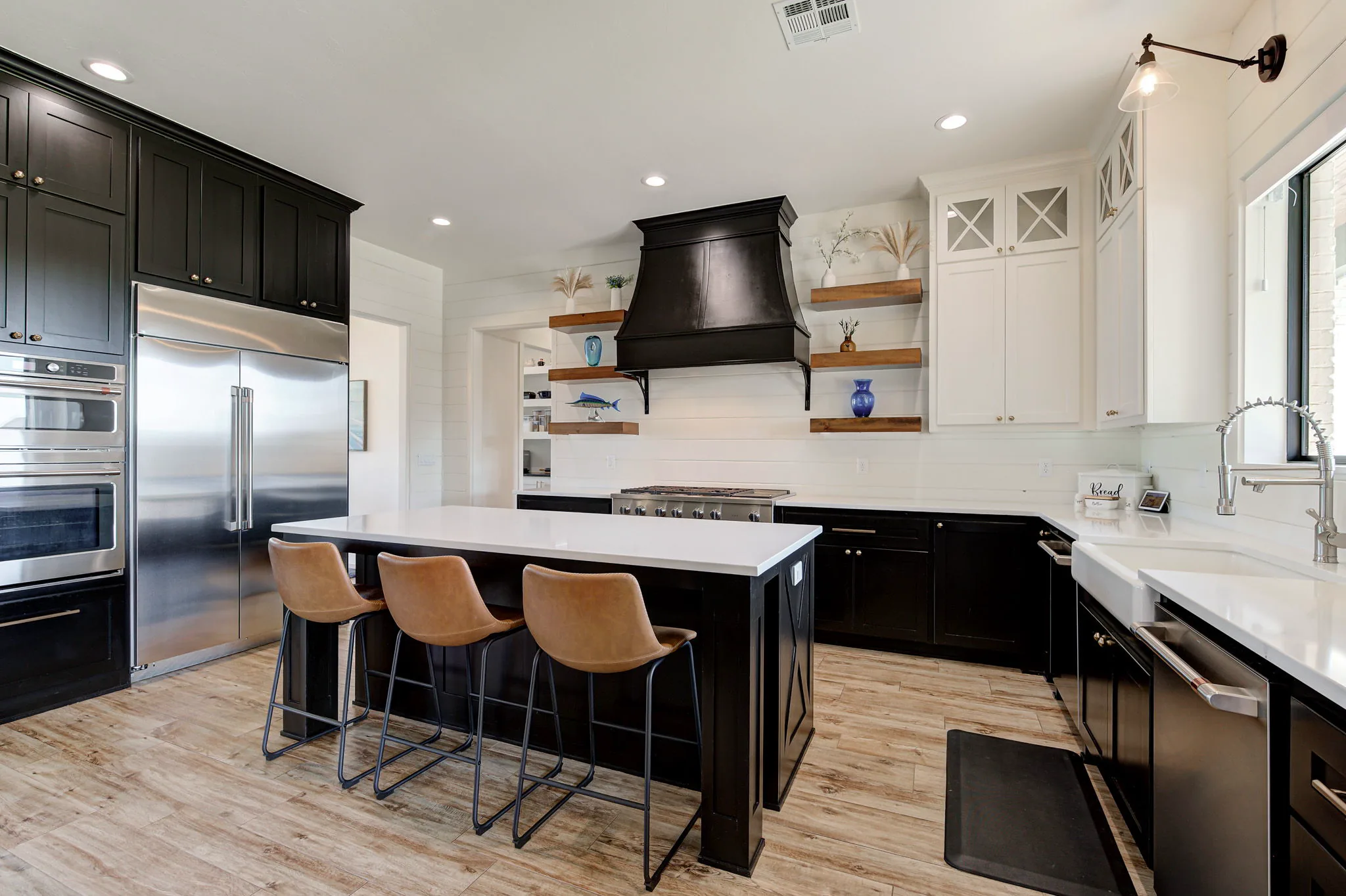 Kitchen with a professional gas cooktop, quartz counters, and a farmhouse apron-front sink