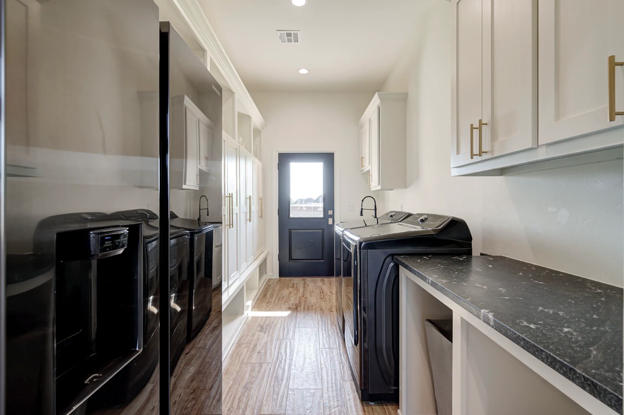 Laundry and mudroom with a side-by-side washer and dryer, built-in lockers, a utility sink, and an exterior door